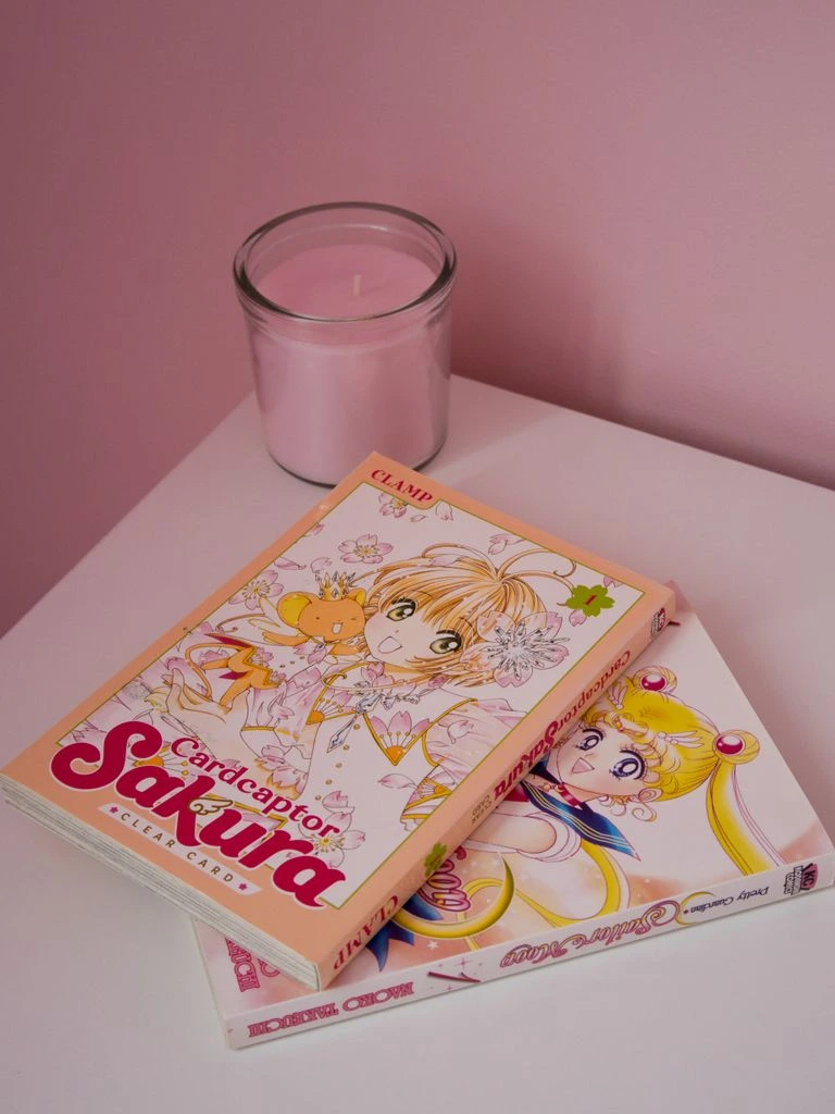 Three comic issues fanned out on a dark desk surface